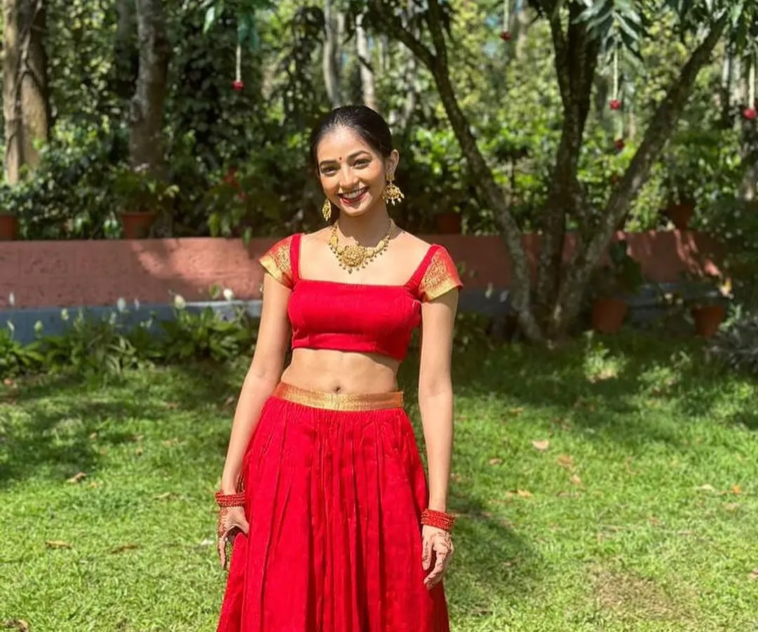 For a bold and joyful celebration, I designed this vibrant red crop top and skirt set. The modern silhouette with a square neckline is balanced with traditional gold detailing on the sleeves, creating a perfect fusion look for a Sangeet or pre-wedding event.