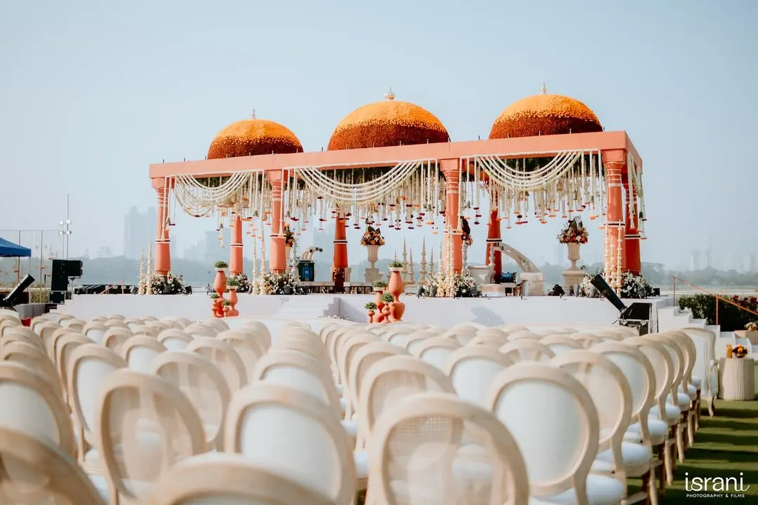 I love creating mandaps that honor timeless traditions while making a grand statement. For this ceremony, I designed magnificent marigold domes set against the city skyline, blending cultural richness with modern luxury for a truly regal wedding.