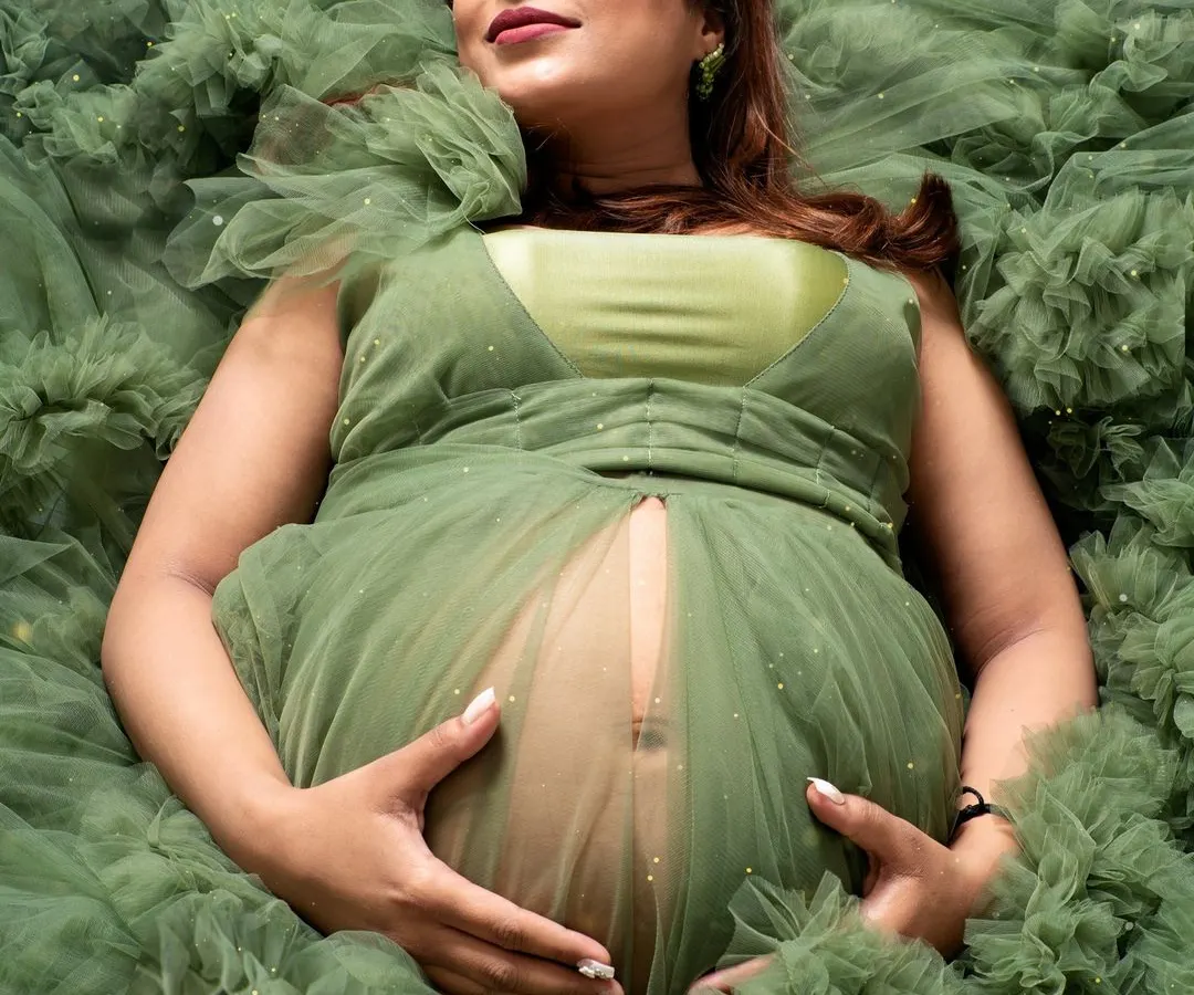 A quiet moment of connection with your baby. I designed this shot to feel like you are floating in a sea of dreams, surrounded by the soft ruffles of this gorgeous green gown from my collection.