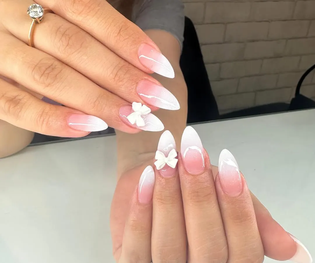 A beautiful baby boomer ombré in a sharp stiletto shape, made even more special with delicate, hand-sculpted 3D acrylic bows. This is a popular choice for bridal nails and special events.