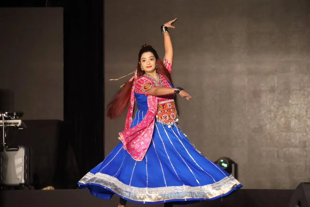 As a 'dancing anchor', my energy is my signature. This moment from the 'Rangilo Re' Navratri festival captures the pure joy and movement I bring to the stage, encouraging everyone from the youngest guest to the eldest dadi to join in the celebration and feel the rhythm.