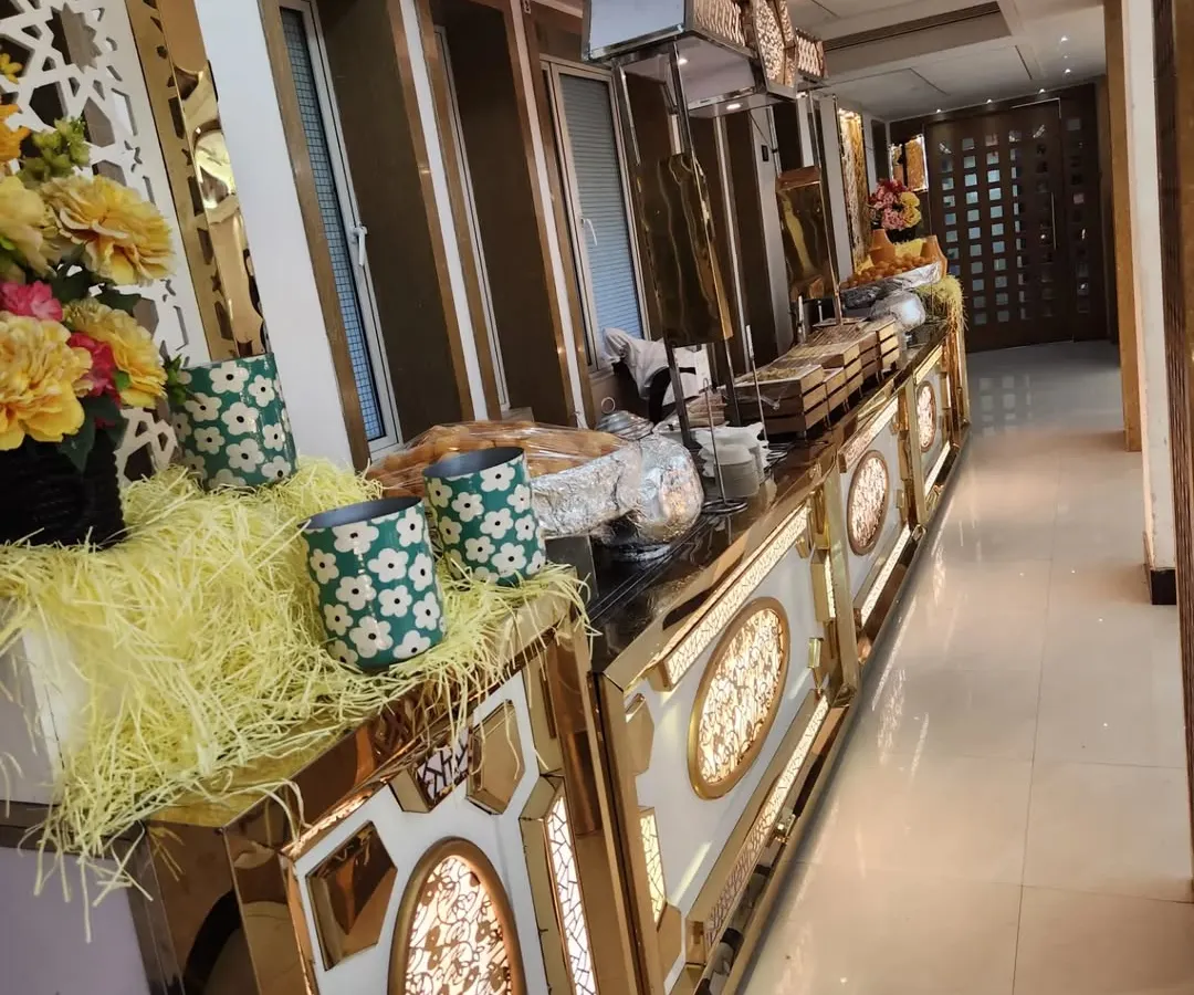 This is one of my premium buffet counter designs, featuring built-in lighting and elegant gold trim. I believe the food setup should be as impressive as the food itself, creating a luxurious atmosphere for your guests.