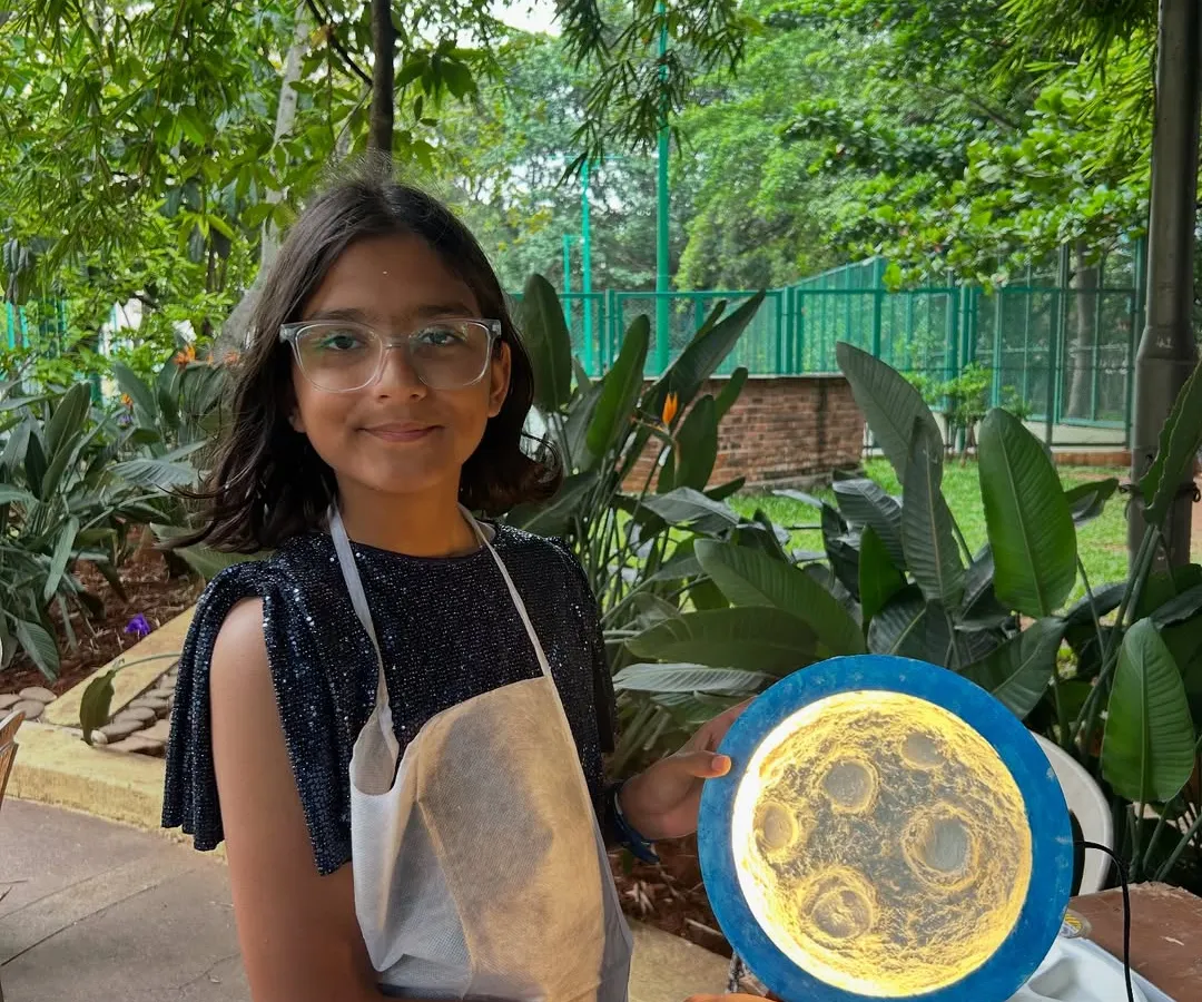 One of my most magical workshops is moon lamp making. Here, a young artist holds her finished lamp, a glowing personal creation she can take home. It’s a wonderful activity that lights up faces with as much joy as the lamps themselves.