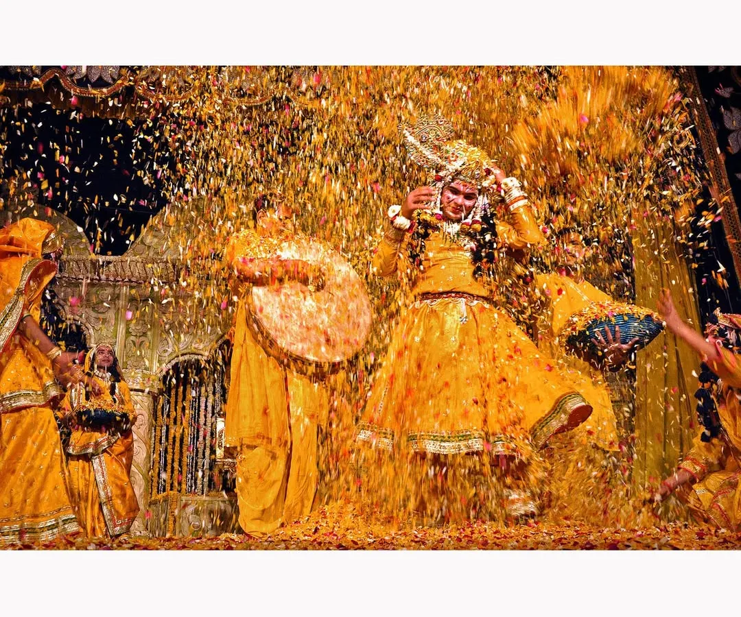 The explosive joy of Holi celebrations captured in a shower of golden petals. This photograph is about the energy and chaos of the moment, a vibrant cultural scene frozen in time. It is a testament to the power of color in documentary storytelling.