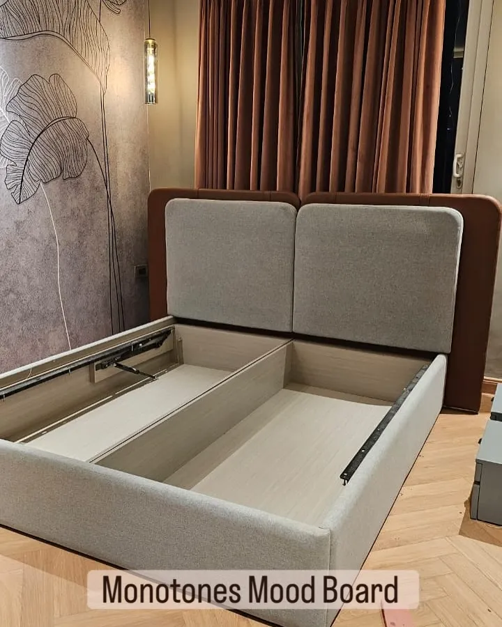 My hydraulic beds are a game-changer for storage. This design features a dual-tone upholstered headboard and a powerful lift-up mechanism, revealing a huge amount of organized space for your linens and extra items.