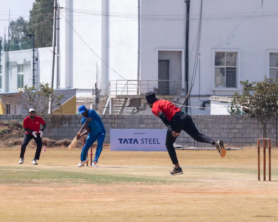 We bring corporate sports to life with professional tournament management. This action shot from the Indian Corporate Cricket League shows our on-field execution, complete with prominent branding for sponsors like Tata Steel.