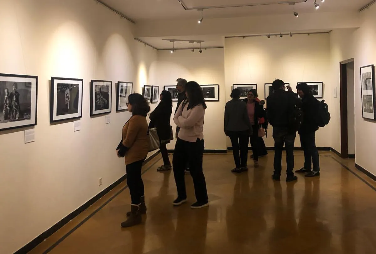 Visitors engaging with the poignant photography at our Gurgaon centre gallery. We create an immersive environment where guests can connect deeply with the stories behind the art.