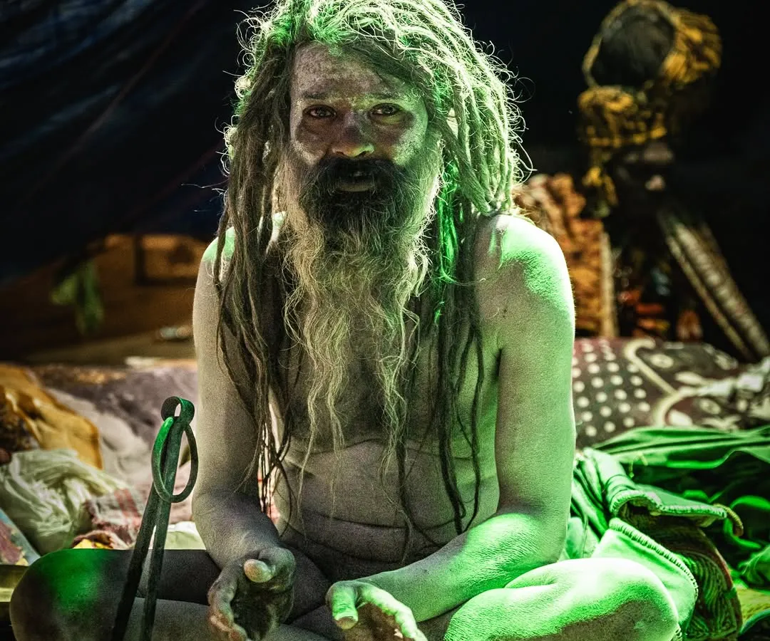 The atmosphere inside the sadhus' tents was otherworldly. I used the available light to capture the moody, intense feeling of the space. This man, covered in sacred ash with his trishul, sat with a quiet power that was palpable.