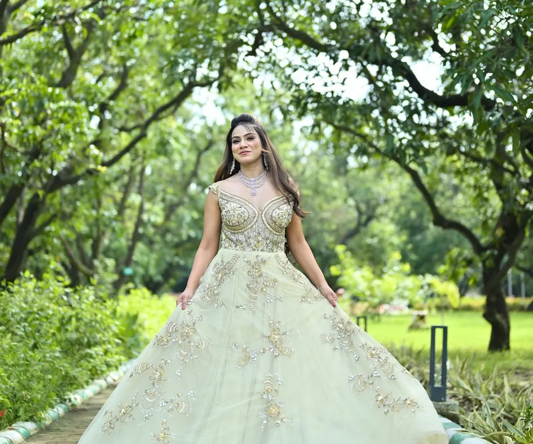 An elegant, flowing gown in a soft pastel green, detailed with delicate silver and gold embroidery. This is a perfect choice for a modern reception or engagement ceremony, offering a blend of tradition and contemporary style.