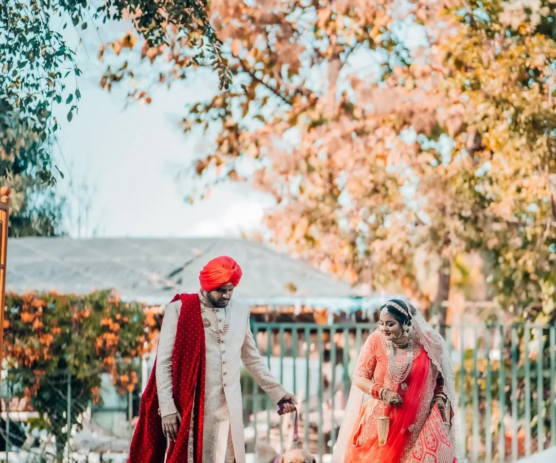 A beautiful moment from a Sikh wedding, where the couple takes a stroll with their beloved golden retriever. We love including pets in your big day, capturing the joy they bring to your family story.