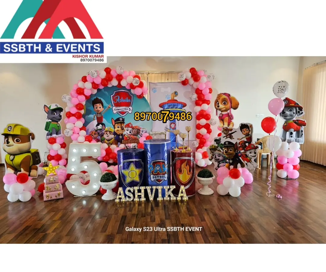 For this 5th birthday, I designed a full Paw Patrol theme. The setup includes character cutouts of the entire pup squad, a large light-up number '5', custom-themed pedestals for the cake, and a vibrant red and pink balloon arch.