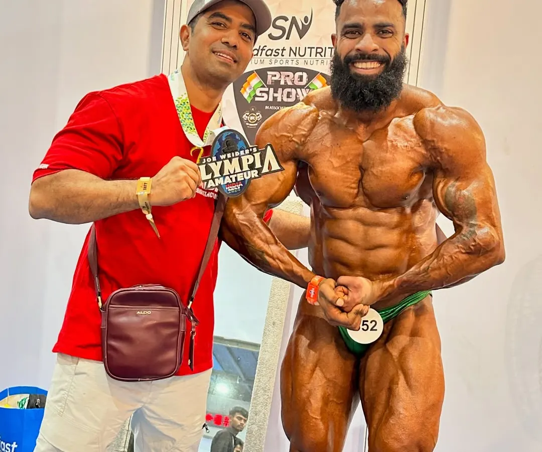 This is the moment a dream comes true. Here I am with my athlete, Bantu Rathore, after he won the Mr. Amateur Olympia title. I treat my clients' dreams as my own, and this is the result of that dedication.