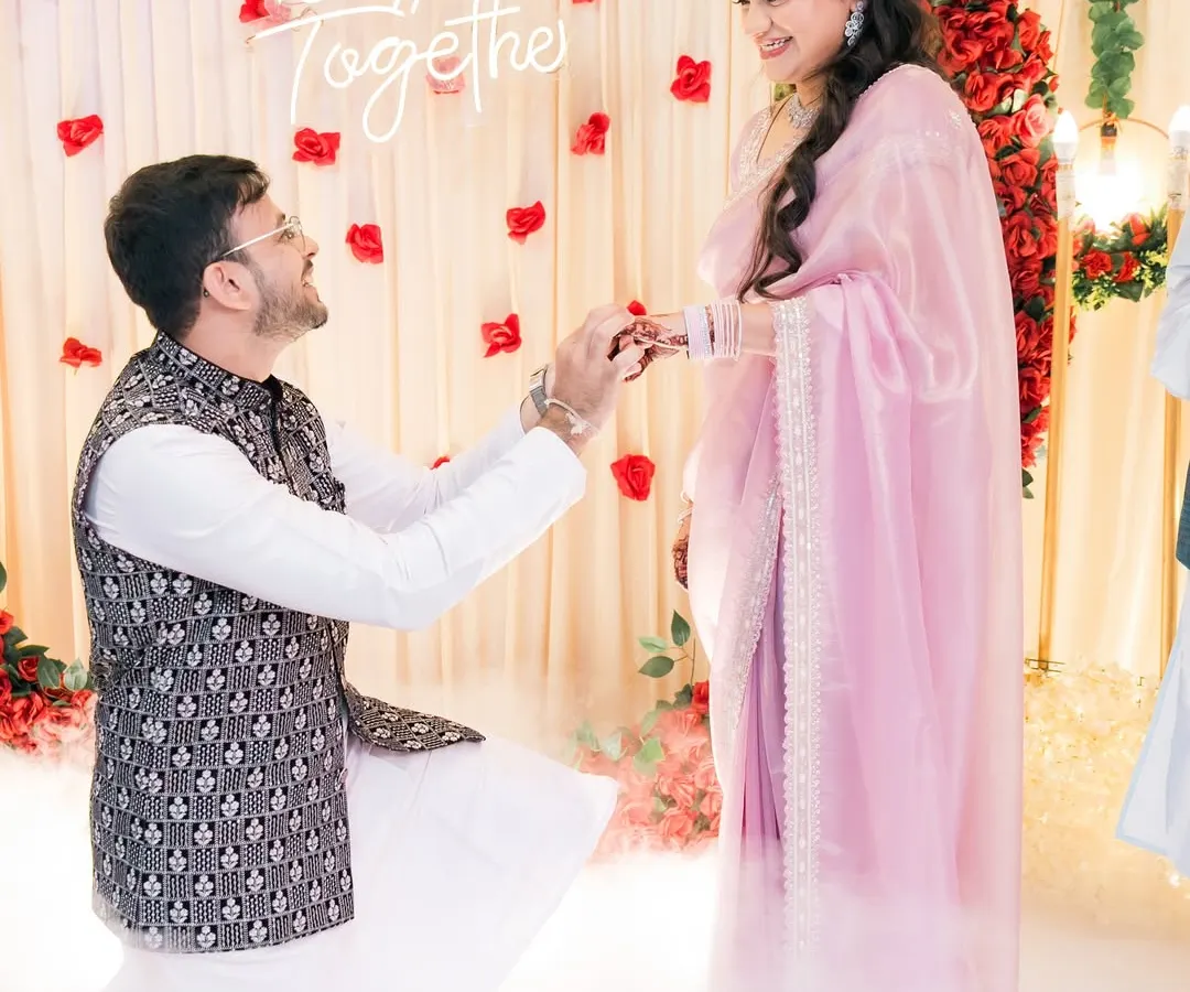 The moment it becomes official. We love capturing the ring exchange, especially with such a beautiful setup. The soft lighting and "Better Together" sign made this engagement ceremony feel magical.