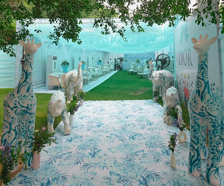 For a bride who loves high fashion, I designed a Mehendi inspired by Dior's iconic patterns. This entrance features custom-painted animal sculptures, setting the stage for a chic, couture-themed afternoon.