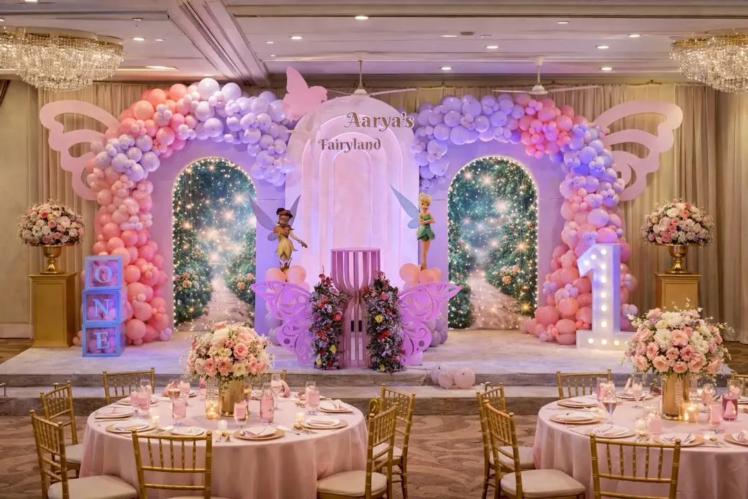 For a touch of magic, I design enchanting worlds like this "Fairyland" theme. The setup includes custom-built sparkling arches, whimsical fairy cutouts, and coordinated table settings to bring the entire fairytale to life.