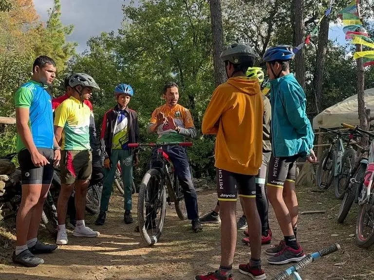 A key part of our workshops is the pre-ride briefing. Here, our coach Rakesh Rana explains the day's plan and shares essential techniques with a group of young riders before they hit the trails in Mukteshwar.