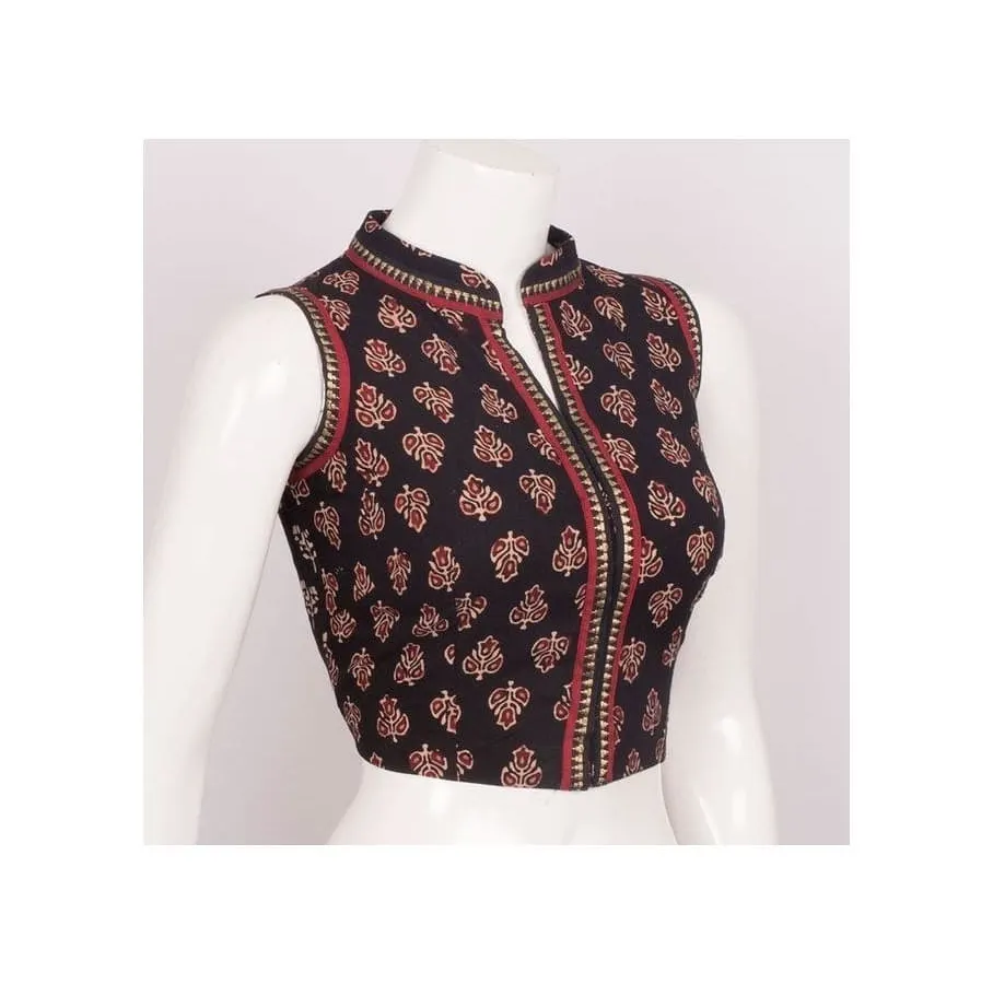 For a contemporary ethnic look, I can create pieces like this sleeveless blouse with a stylish high collar. Made from a classic printed fabric, it is tailored to provide a sharp, flattering fit that pairs well with a variety of sarees.