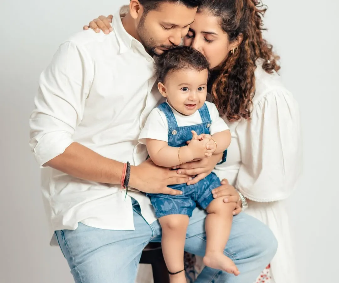 This intimate studio family portrait captures the tender love between parents and their baby boy. We focus on creating a comfortable space for these genuine moments of connection.