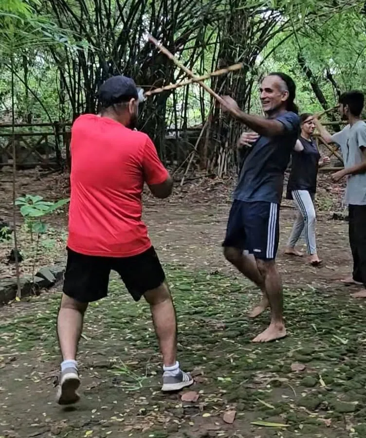 Training isn't confined to four walls. Here in the forest, we practice stick fighting drills, learning to use our environment and stay aware. This is what I mean by being ready for anything, anywhere.