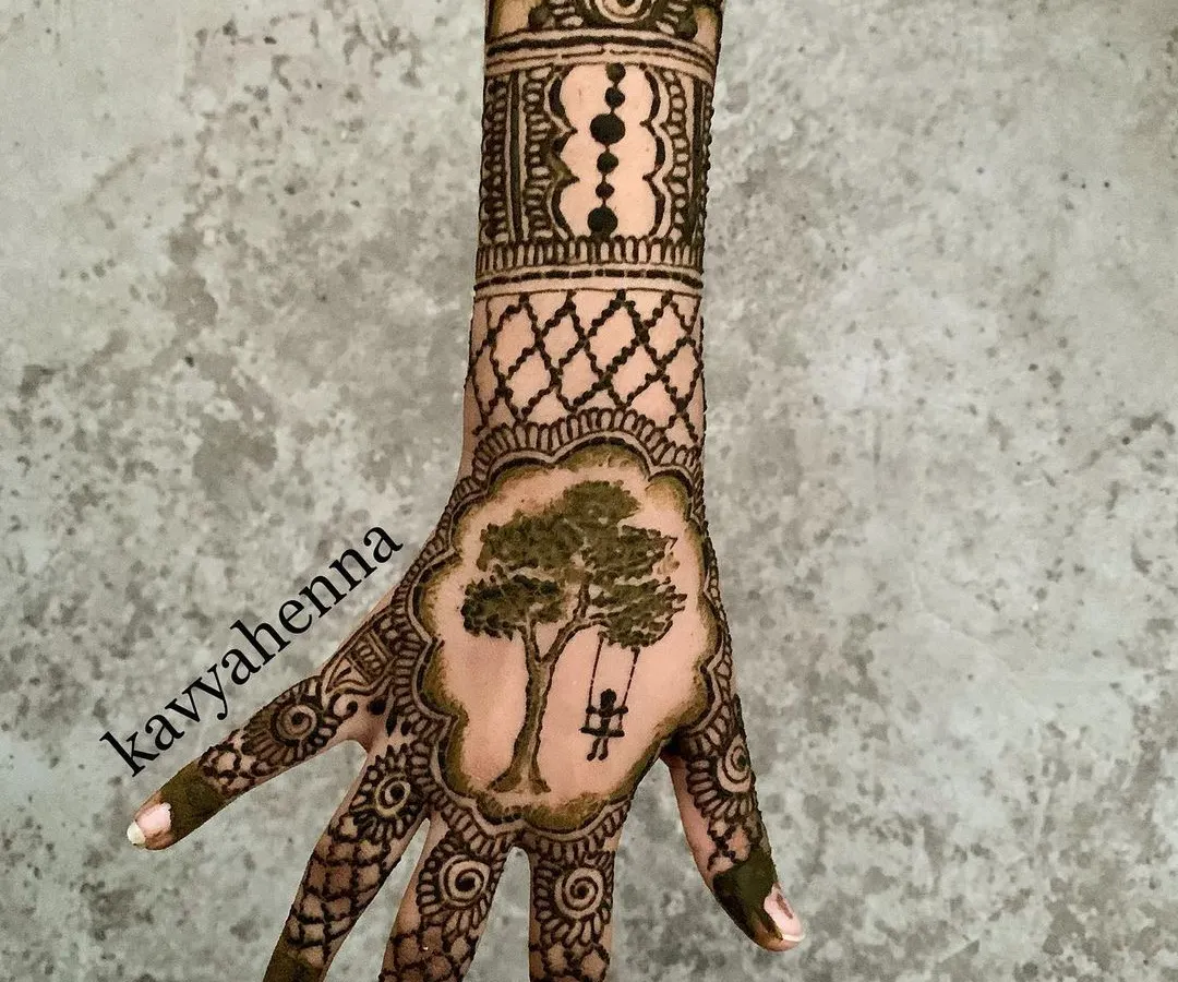 This design tells a small story, featuring a person on a jhula (swing) set within a detailed pattern. It’s an example of how I can incorporate personal and narrative elements into a party henna design.