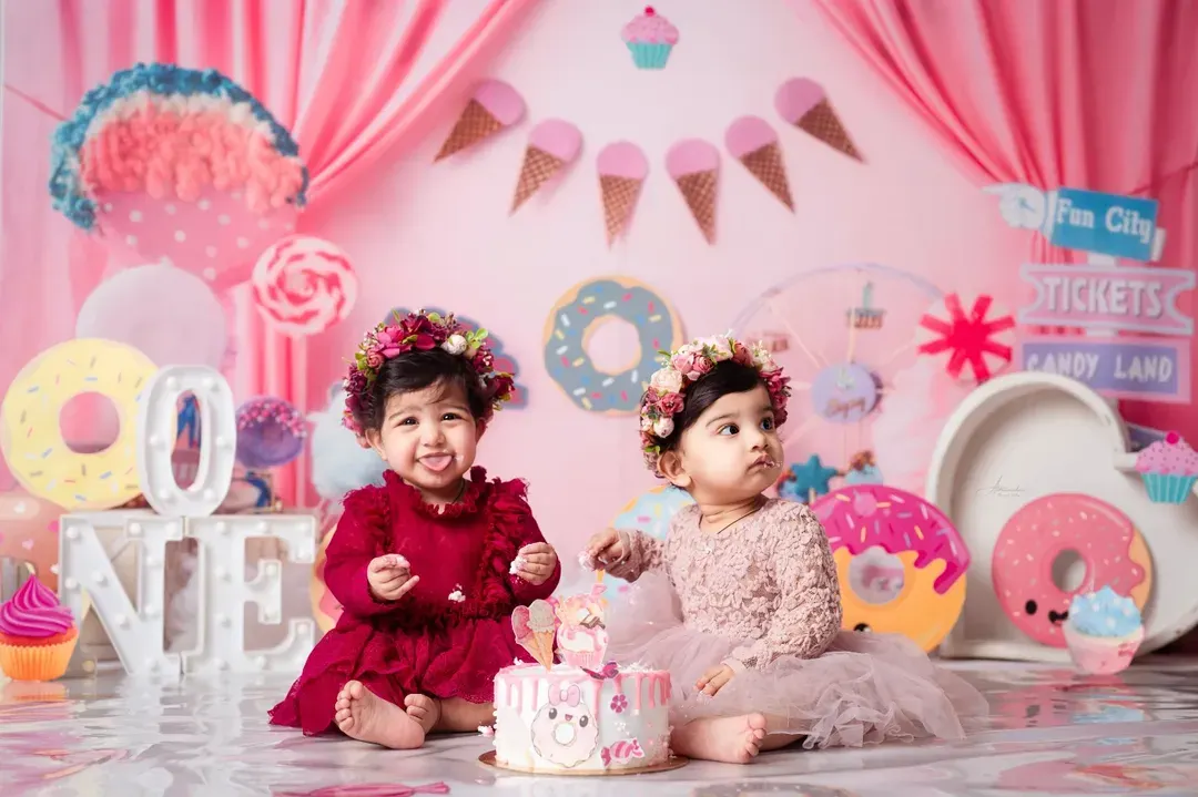 We go all out for first birthdays! This sweet duo is celebrating in our custom 'Candy Land' theme, one of the many imaginative worlds we can create for your child's special day.
