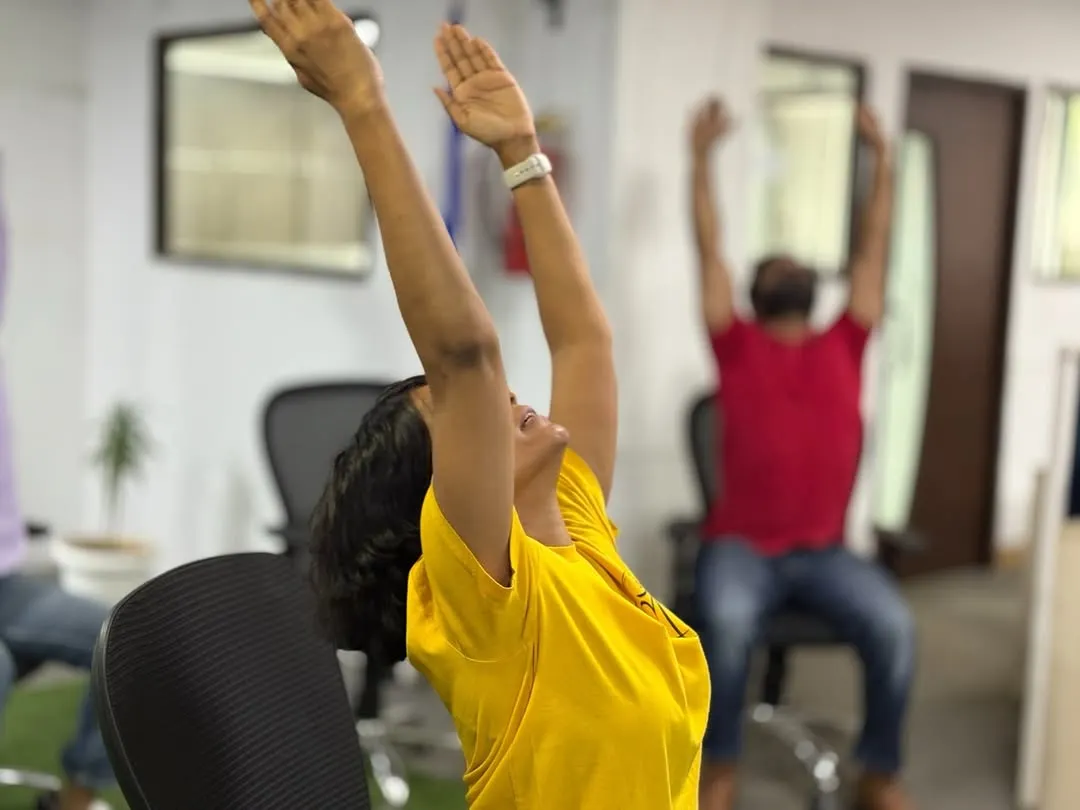 You don't need a lot of space to find relief. This simple seated stretch, done right at the desk, is one of the many chair yoga techniques I teach to help employees release tension in the shoulders and upper back caused by long hours at the computer.