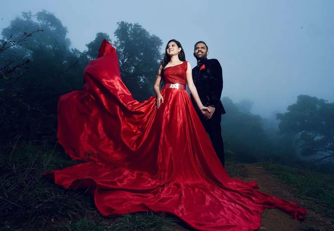 For dramatic pre-wedding photoshoots like this one in the misty hills of Chikmagalur, the makeup needs to be both beautiful and resilient. I designed a look that enhanced her features and paired beautifully with this magnificent red gown, ensuring she looked flawless throughout the outdoor shoot.