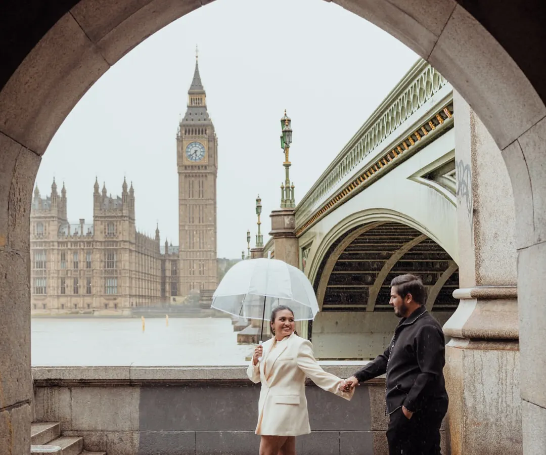 A classic London romance, complete with a little rain. We framed this shot through a stone archway, using the iconic Big Ben as a backdrop to create a timeless portrait that feels like a scene from a movie.