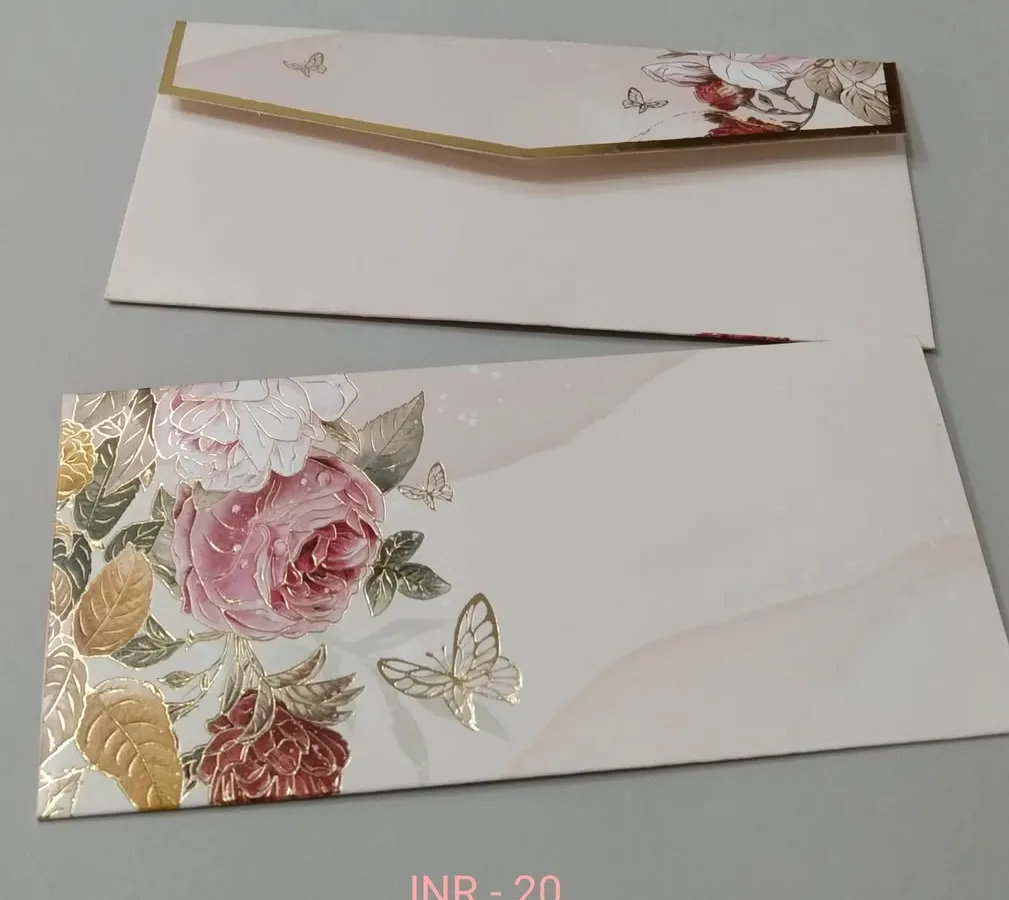For a more modern touch, this envelope features a soft watercolor background with a spray of pink and gold foil flowers and butterflies. It's perfect for engagements, receptions, or festive gifting.