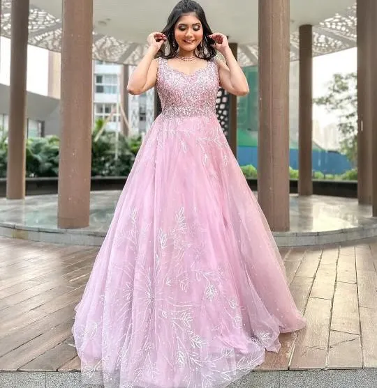 Feel like a princess in this beautiful pink ball gown. The delicate silver embroidery on the bodice and the flowing tulle skirt make it a dream outfit for pre-wedding photoshoots or reception parties.
