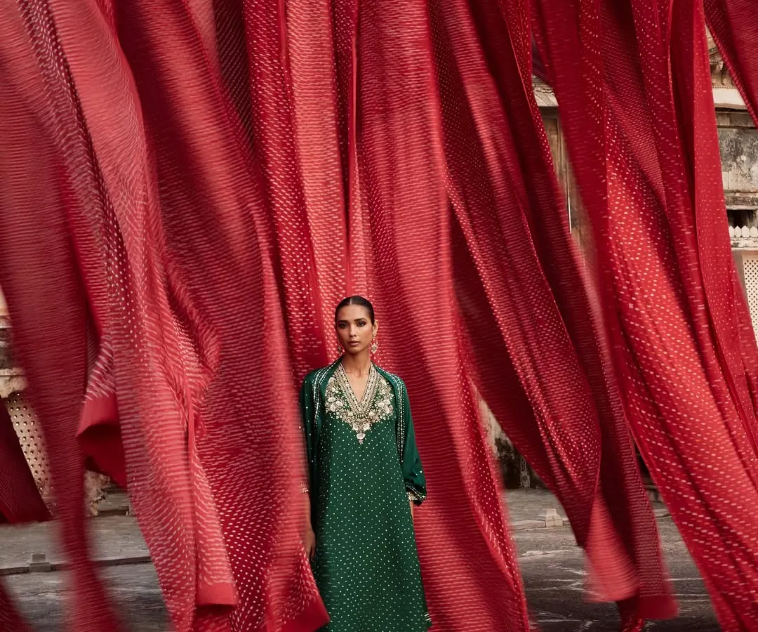 For this Anita Dongre campaign, I wanted to create a powerful visual ode to Indian craftsmanship. Here, a model stands in an emerald green ensemble against a backdrop of vibrant red Bandhani textiles, creating a striking contrast that celebrates the beauty of traditional tie-dye techniques from Rajasthan.