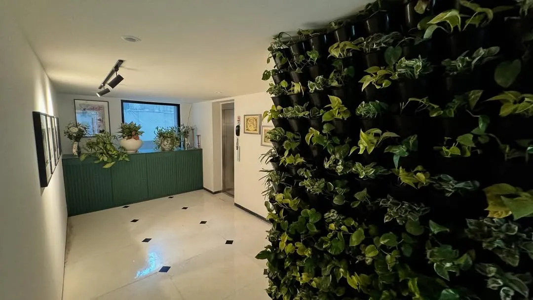 We designed this biophilic entry foyer to create a welcoming and soothing first impression. A full-height living wall brings vibrant nature indoors, contrasting beautifully with the polished floors and clean, modern lines of the space.
