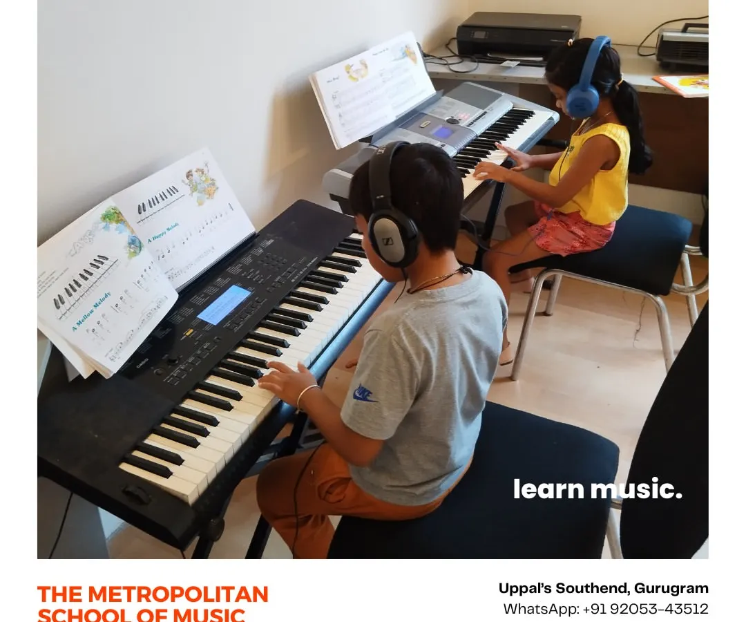 Learning is often more fun together. In our Gurugram studio, two young students are engaged in a keyboard lesson, using headphones to focus on their individual practice while learning side by side.