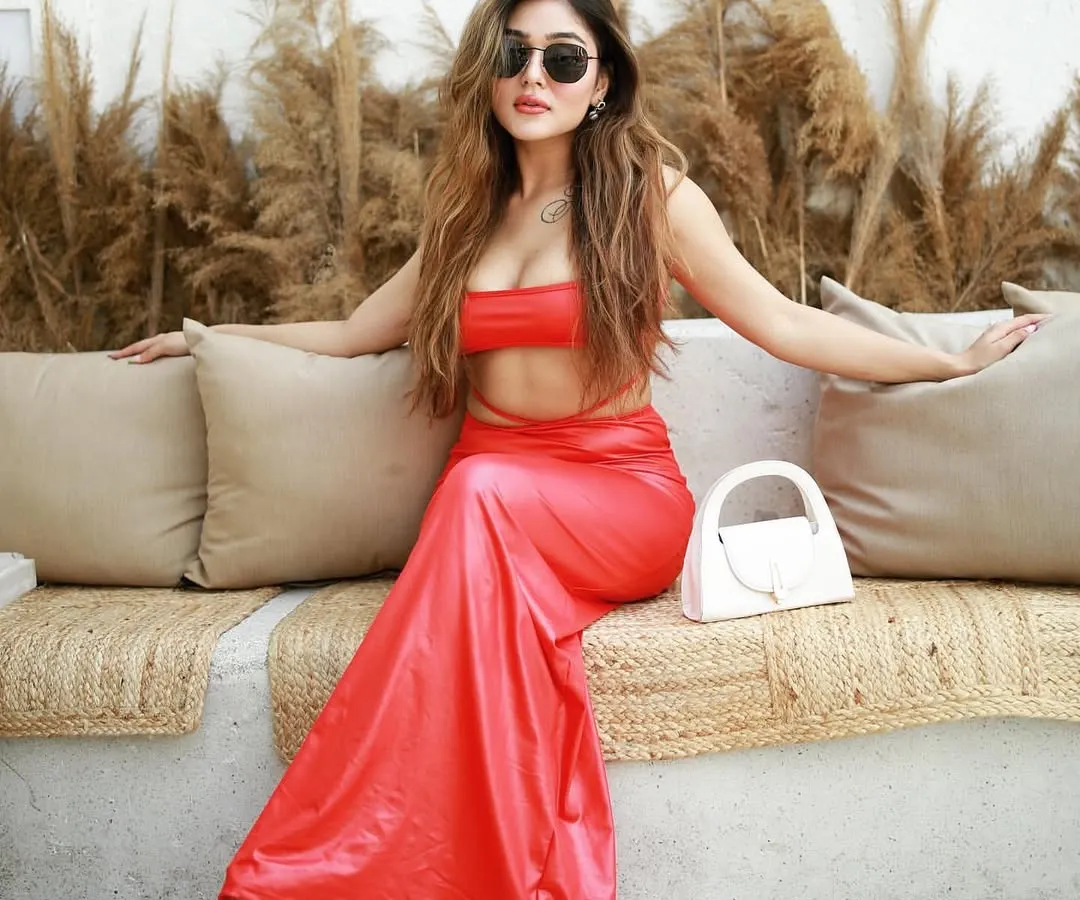A full-length shot of a model in a vibrant red co-ord set, posing confidently in a chic, sunlit cafe. This image is perfect for influencers and brands looking for stylish, commercial-quality content.