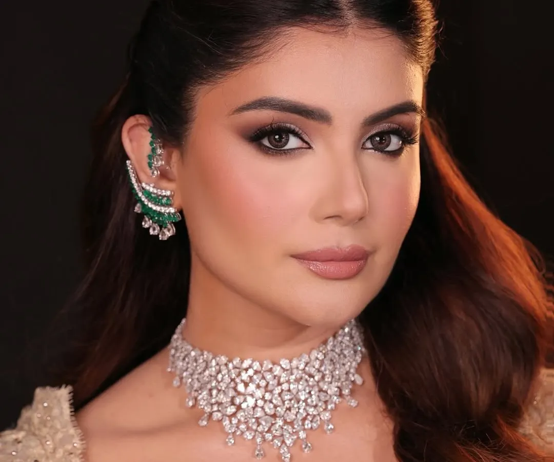 This is couture glamour for a cocktail or reception event. The look features bronzed, glowing skin and a dramatic smoky eye, paired with a nude lip to create a perfect balance of sophistication and allure.