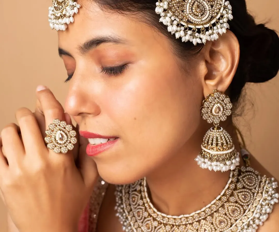 Modeling for bridal jewellery requires attention to detail and the ability to convey emotion. This close-up shot highlights an intricate kundan and pearl bridal set, perfect for wedding campaigns and catalogues.