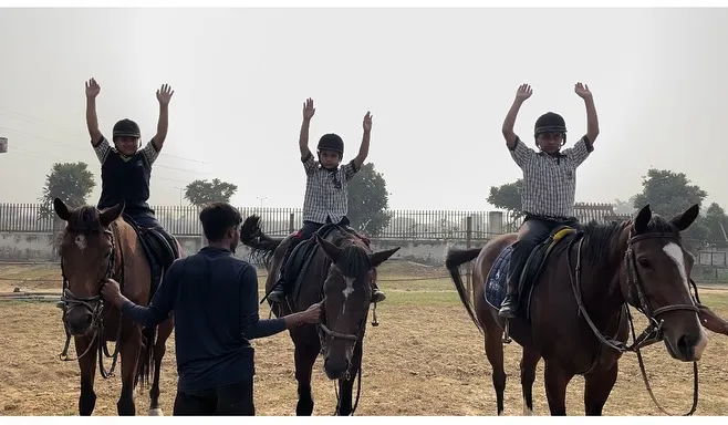 Young riders learning balance and confidence under the watchful eye of our instructor. We focus on building foundational skills in a safe and encouraging environment for kids.