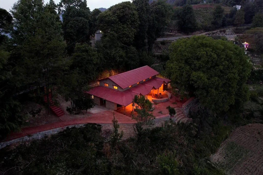 The Sargakhet Handicraft Centre, once a dilapidated British-era post office, is now a warm, inviting hub for local artisans, seen here glowing at dusk in the Mukteshwar valley.