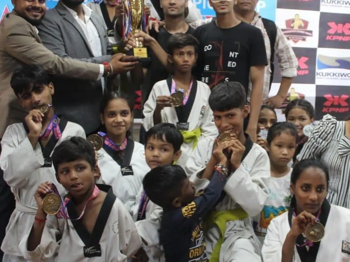 A proud moment for my team from the Warrior Fight Club after a successful championship. You can see the joy and sense of accomplishment as the students hold up their trophy and show off their hard-earned medals. This is the result of their dedication and hard work.