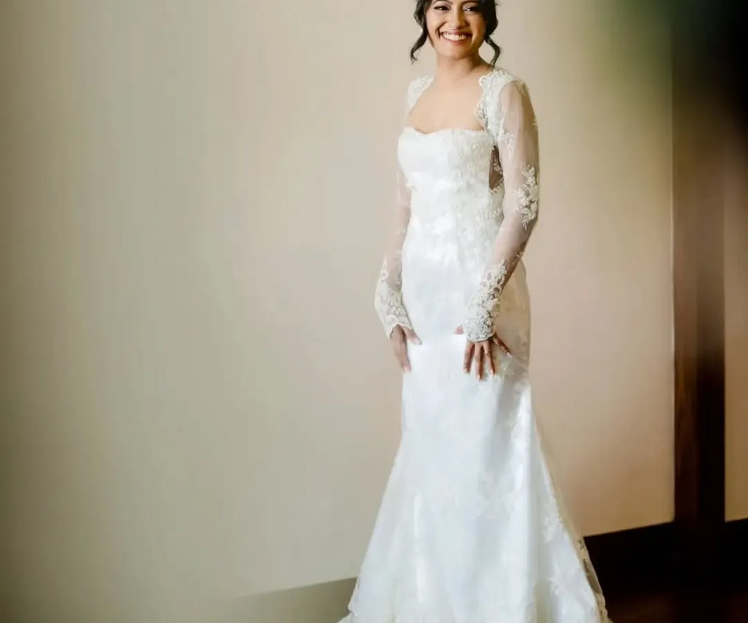 A full-length view of my lovely Catholic bride, looking absolutely serene and elegant. Her custom lace gown is complemented by a soft, romantic makeup look and a classic bridal updo, all designed to create a timeless and graceful silhouette for her walk down the aisle.