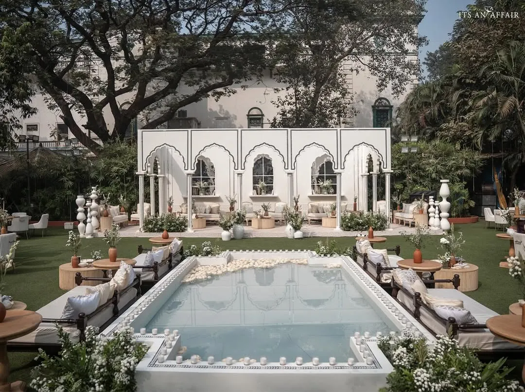 We designed this 'Oasis of Love' by fusing Mughal architecture with a contemporary garden setup, featuring a central reflecting pool for a tranquil and luxurious daytime wedding.