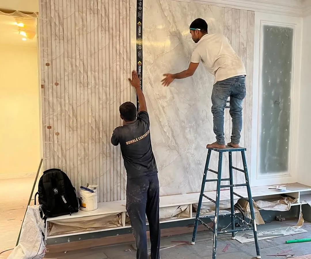 Precision is everything. Here, our team is installing a statement wall, ensuring every panel aligns perfectly. This is where our design-and-build model shines; the same team that envisions the detail also executes it flawlessly on site.