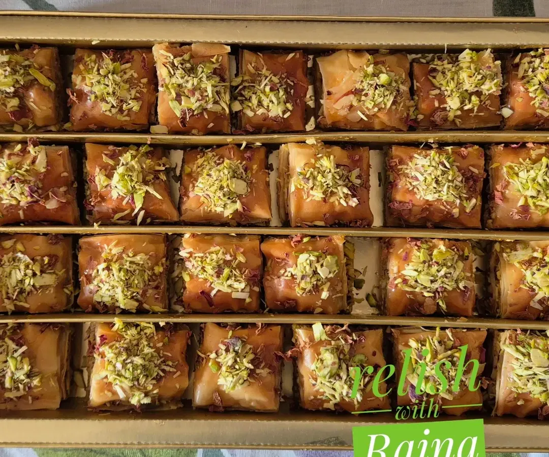 My homemade Square Baklava, a bestseller. Each piece has layers of flaky phyllo dough filled with chopped pistachios and almonds, sweetened with a delicate jaggery and honey syrup, and topped with more nuts.