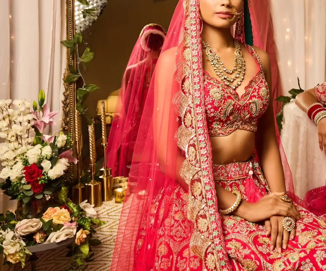 A complete bridal look that feels both classic and modern. I focused on creating a flawless base that would last all day, with defined eyes and a soft lip color to complement the stunning red lehenga. The hair is styled in a clean, elegant updo to keep the focus on the bride's features and her beautiful veil.