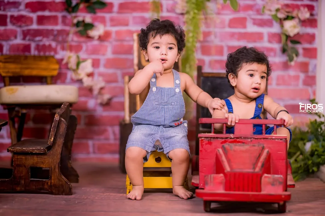Double the fun with our setups designed for twins. This rustic schoolhouse theme, featuring a brick wall, vintage wooden desk, and a classic red toy truck, provides a charming backdrop for capturing the unique bond between siblings.