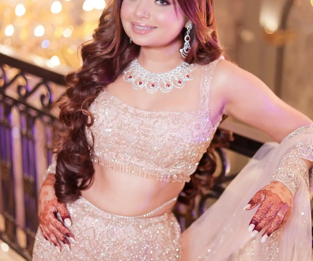 A closer look at the details of this stunning rose-gold mermaid lehenga. The intricate beadwork and sequin detailing sparkle with every movement, making it the perfect glamorous outfit for an engagement or cocktail night.