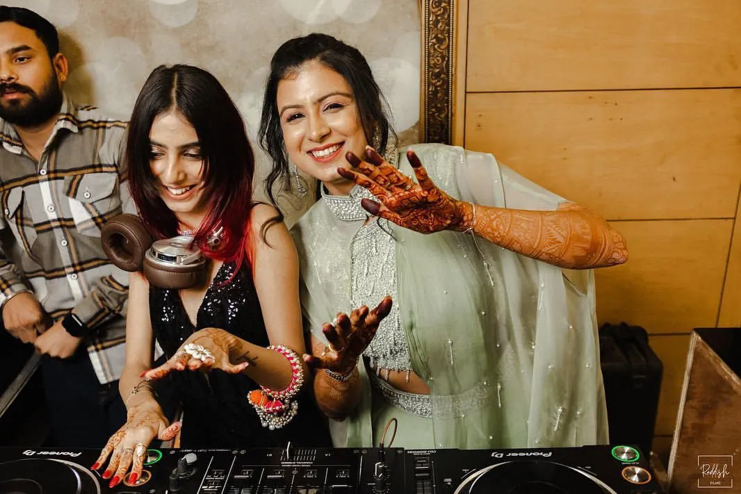 I love being part of special moments. Here I am sharing a laugh with the bride at her sangeet, making sure her big day has the perfect soundtrack.