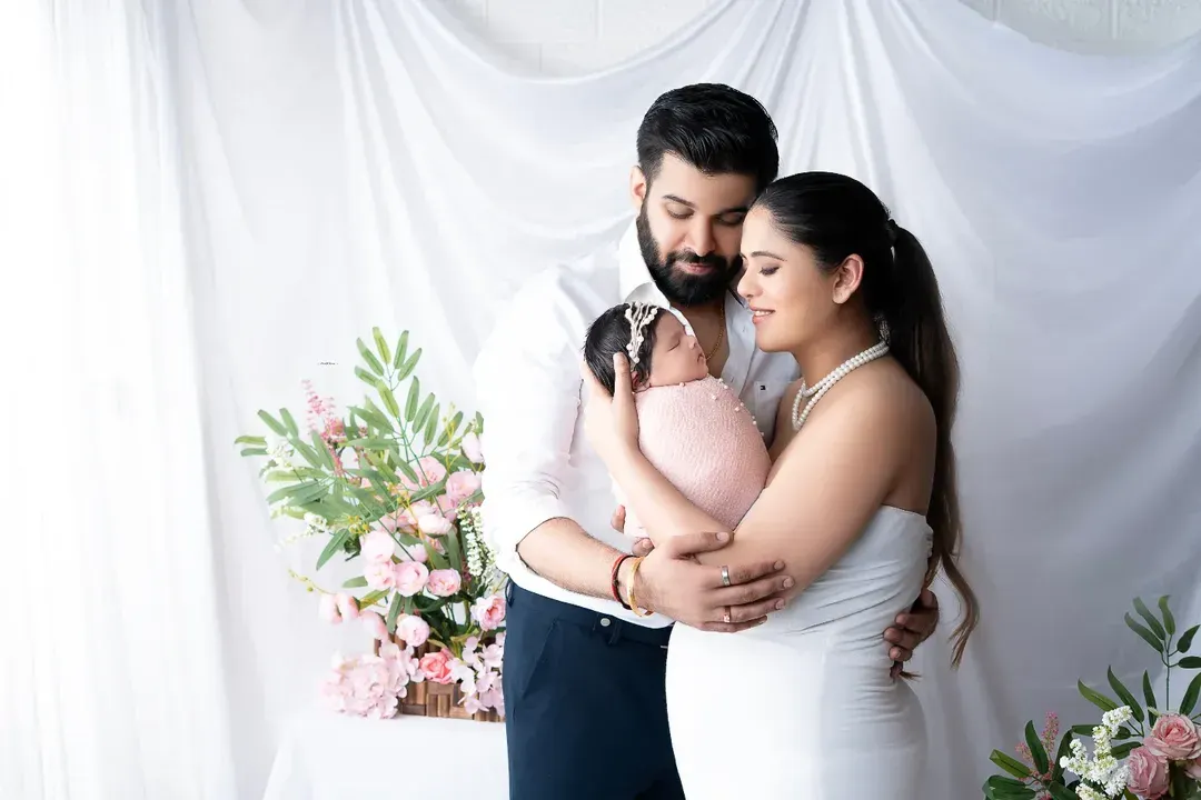 Welcoming their newborn daughter with a tender family embrace. This bright and airy newborn family portrait captures the pure love and joy of the first few days as a new family.