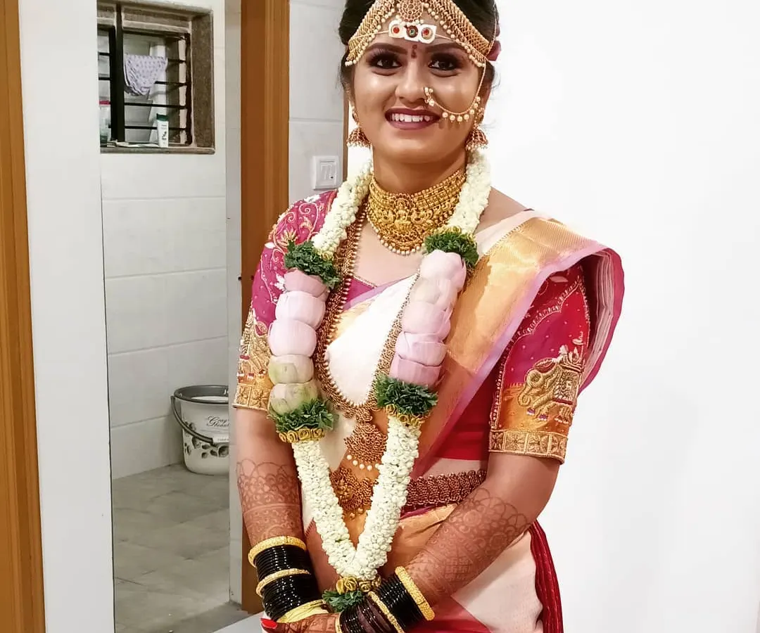 Here is the complete traditional bridal look. I handled the makeup, the hair with the matha patti setting, and the Kanjeevaram saree draping to create a cohesive and elegant style for her big day.