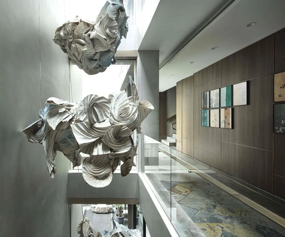 For us, art is a living, breathing element. This cascading installation, a collaboration with artist Ankon Mitra, combines the ancient Japanese dyeing technique of Shibori with the structural folds of origami to retell the story of Radha and Krishna, filling the home's central atrium with light, movement, and mythology.